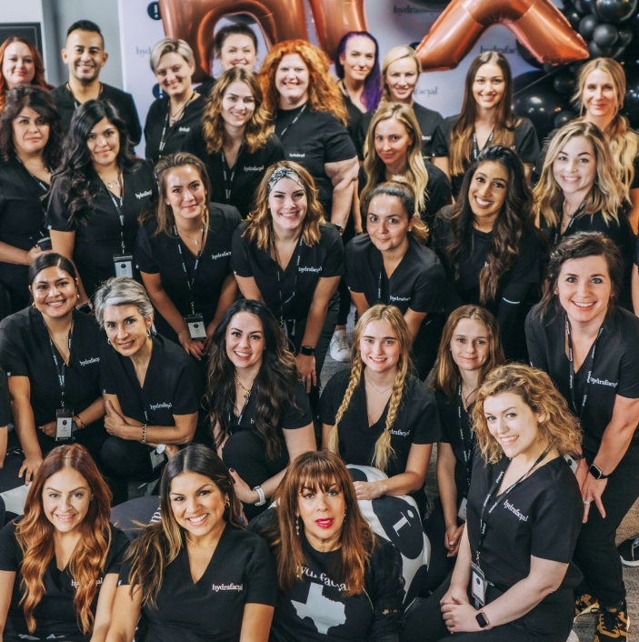 HydraFacial team group photo with staff members in uniform