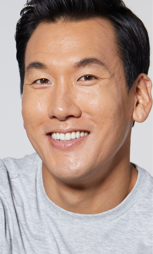 Smiling Asian man with glowing skin after HydraFacial treatment